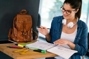 Pretty young college student studying, preparing for exam